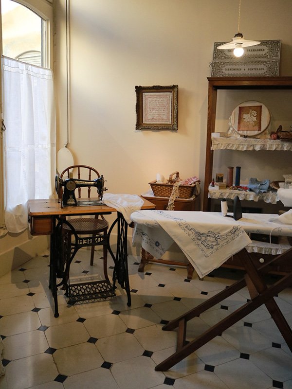 Casa Mila in Barcelona Casa Milà interior room with sewing machine and iron, showcasing historic clothing care in Gaudí’s Barcelona house