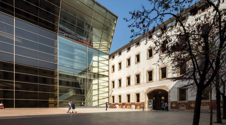 Exterior view of the Centre de Cultura Contemporània de Barcelona showing modern glass façade and urban courtyard in Barcelona