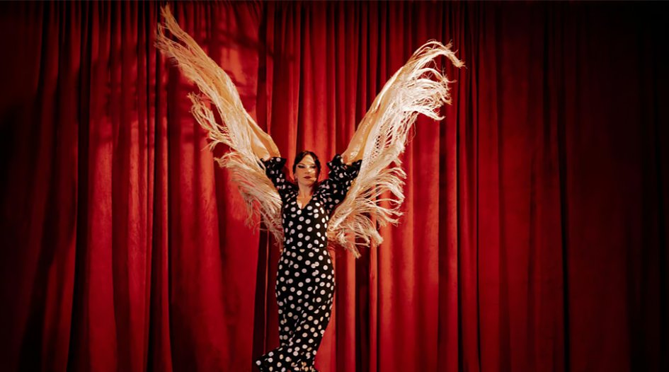 Live flamenco performance with dancers in traditional dress and musicians on stage in Barcelona