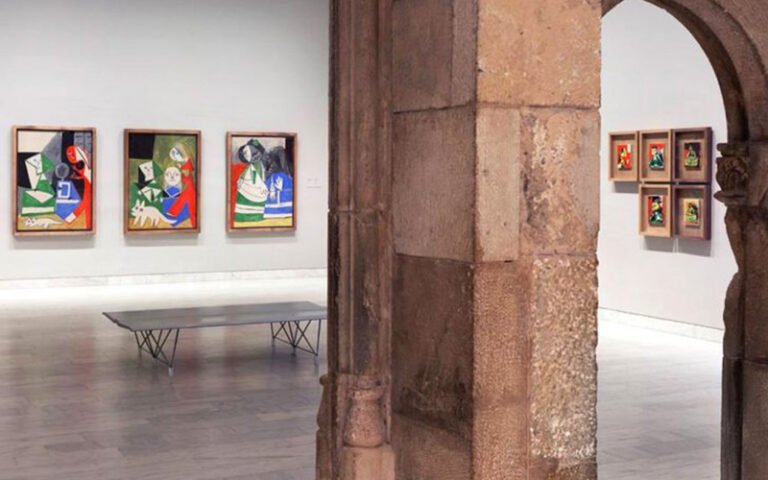 Interior of Picasso Museum in Barcelona with paintings on display.