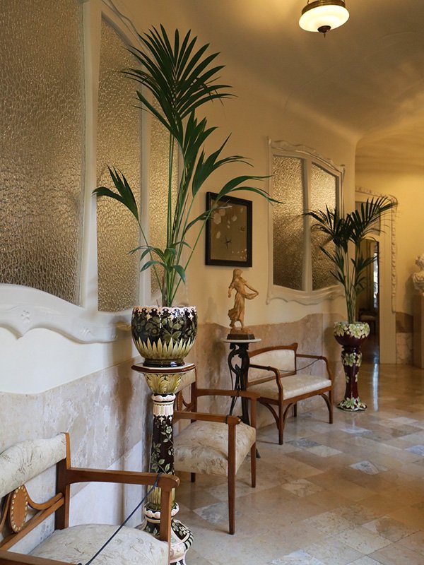 Casa Mila in Barcelona Casa Milà interior hallway in Barcelona with lavish modernist furniture by Antoni Gaudí