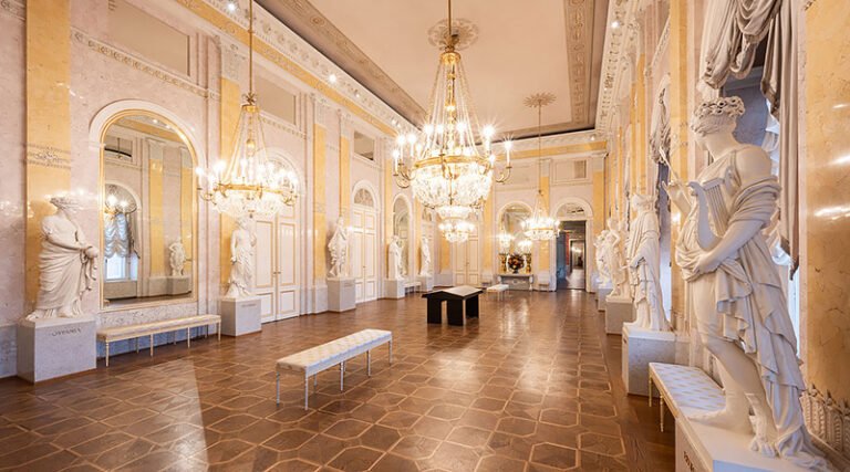Elegant interior gallery room of the Albertina Museum in Vienna showing framed artworks and historic decorative architecture