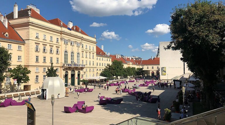 Open courtyard area of the MuseumsQuartier in Vienna with modern seating, people, and museum buildings surrounding the plaza