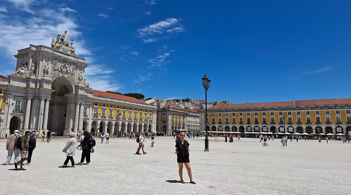 Traveler standing at Praça do Comércio in Lisbon near the waterfront square