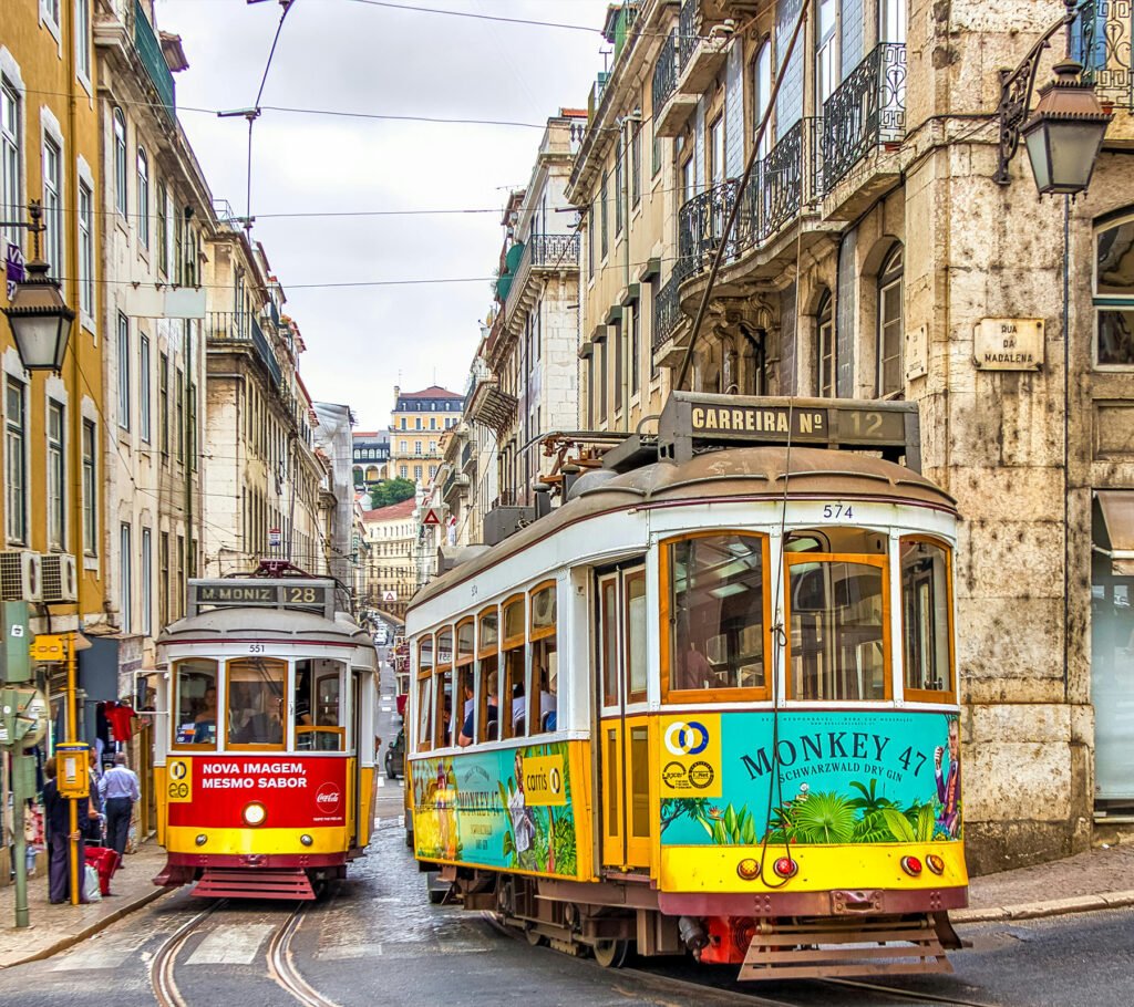 Yellow historic tram moving through the streets of Lisbon with panoramic city views in the background