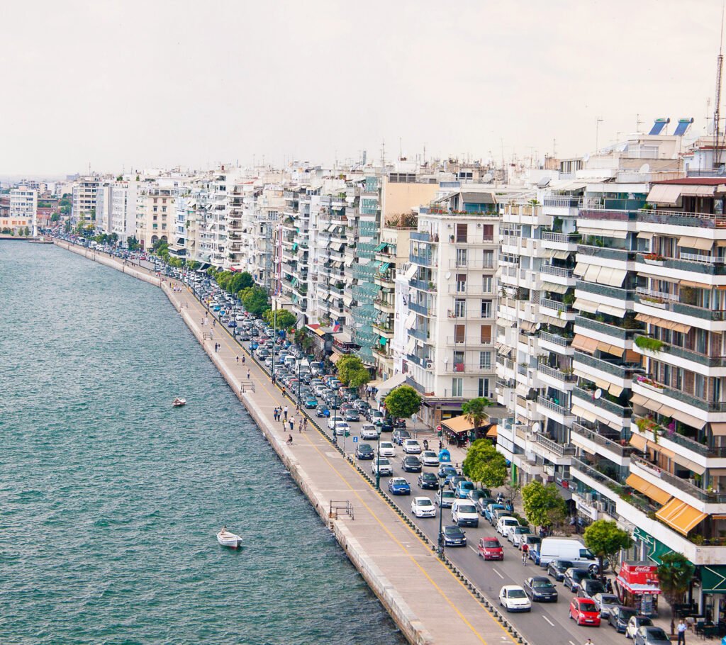 Aerial view of the coastline of Thessaloniki showing the waterfront promenade, sea, and urban shoreline
