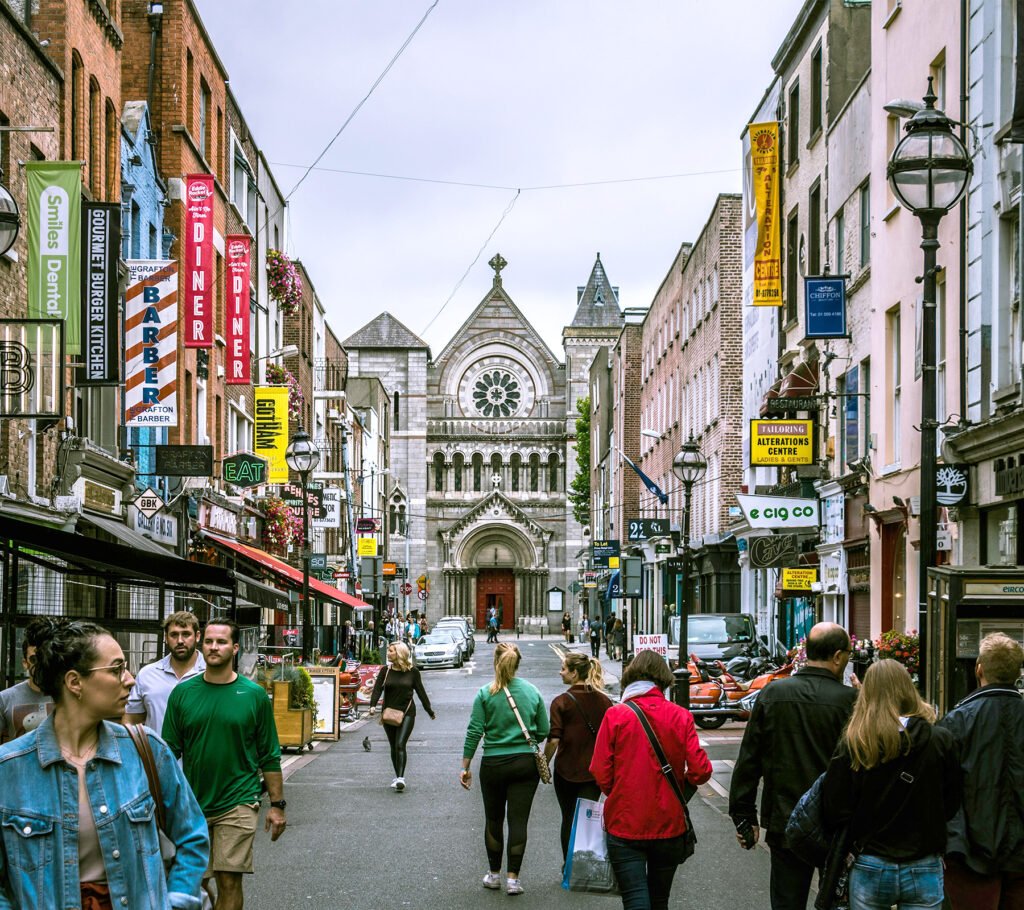 Street view of a narrow urban street in Dublin with buildings, pedestrians, and city atmosphere