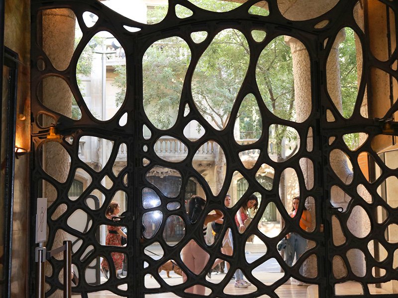 Unique Gaudí-style window inside Casa Milà (La Pedrera) in Barcelona with asymmetrical circular design
