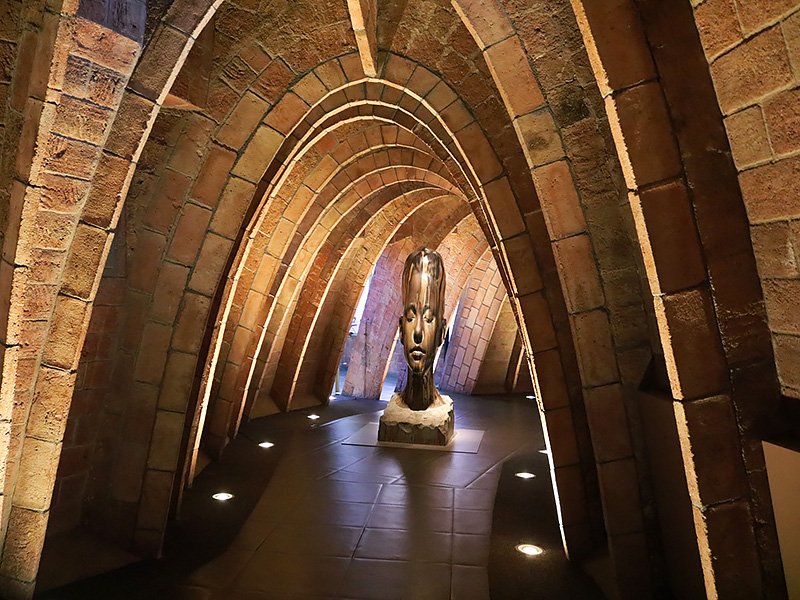 Top floor of Casa Milà (La Pedrera) in Barcelona with arched structure and central sculpture