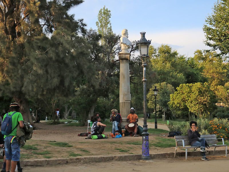 Ciutadella Park in Barcelona Visitors relaxing and playing music on the grass at Ciutadella Park in Barcelona.