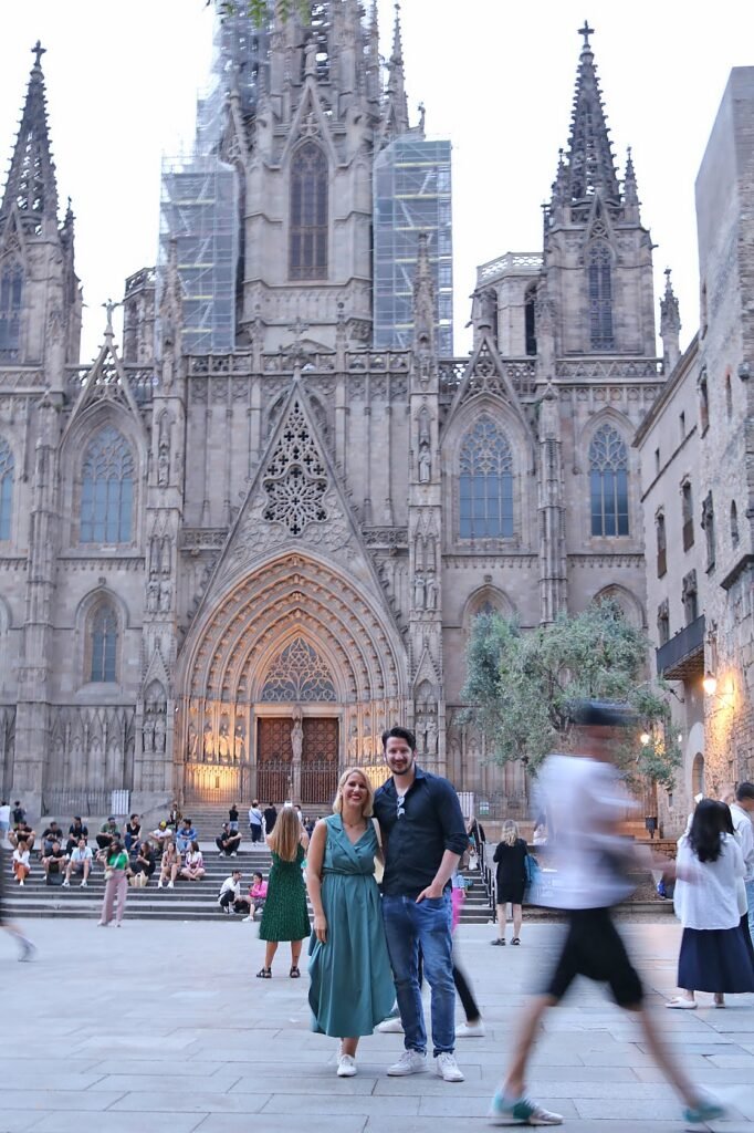 Two travelers standing in front of the Barcelona Cathedral in the Gothic Quarter