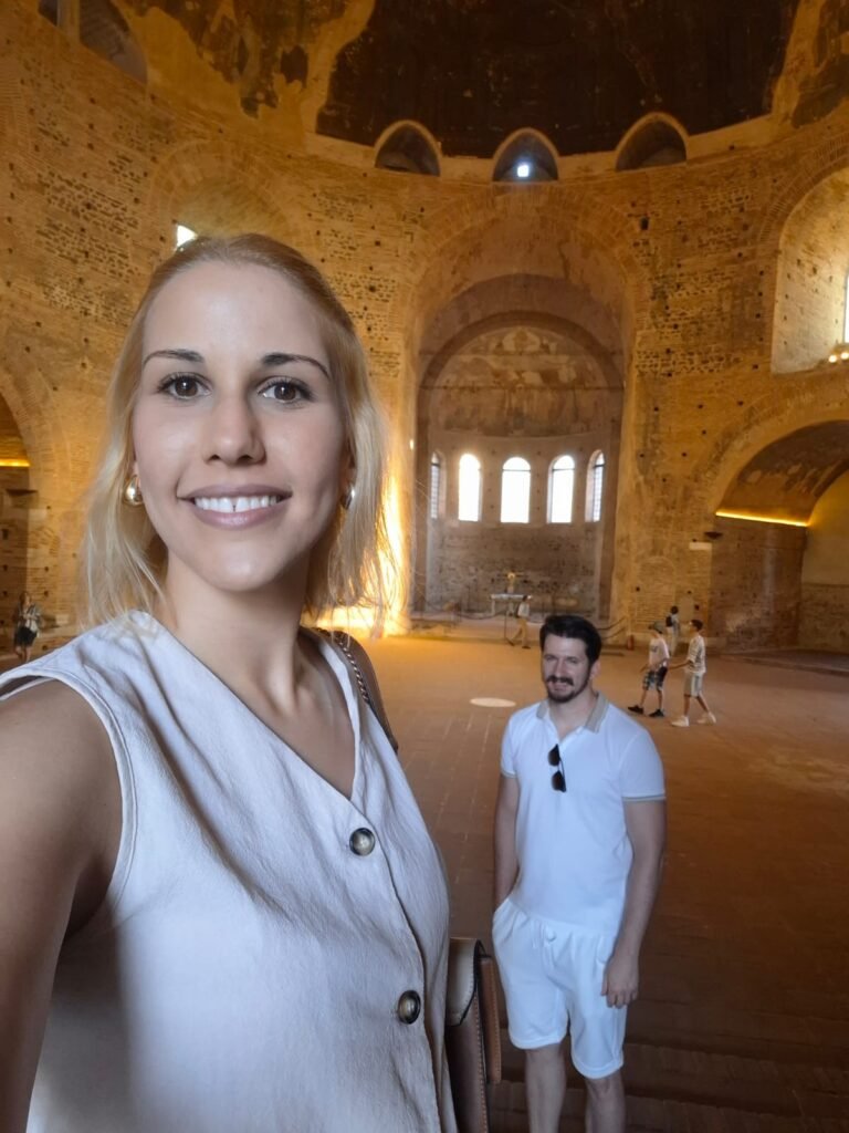Two travelers inside the interior of the Rotunda showing its ancient circular architecture and mosaic details