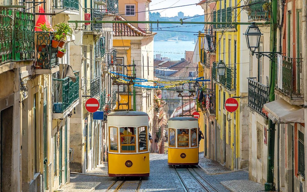 LISBON, PORTUGAL Yellow historic tram moving through the streets of Lisbon with panoramic city views in the background