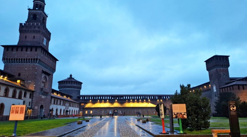 Courtyard view of Sforza Castle in Milan, showing the historic fortress and its surrounding garden.