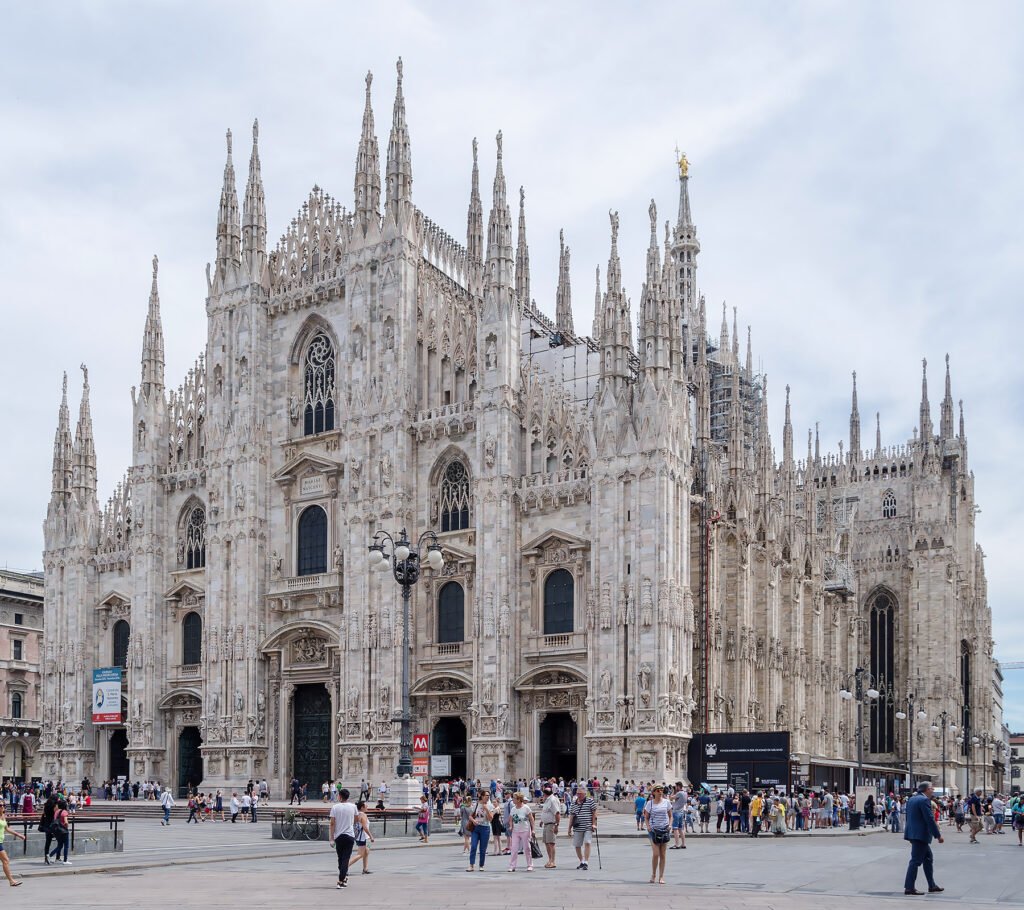 Duomo di Milano in Milan, showcasing its iconic Gothic facade with spires and intricate stone carvings.