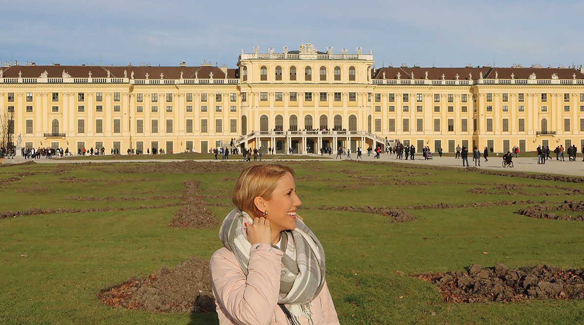 Standing in front of Schönbrunn Palace, one of the best palaces to visit in Vienna